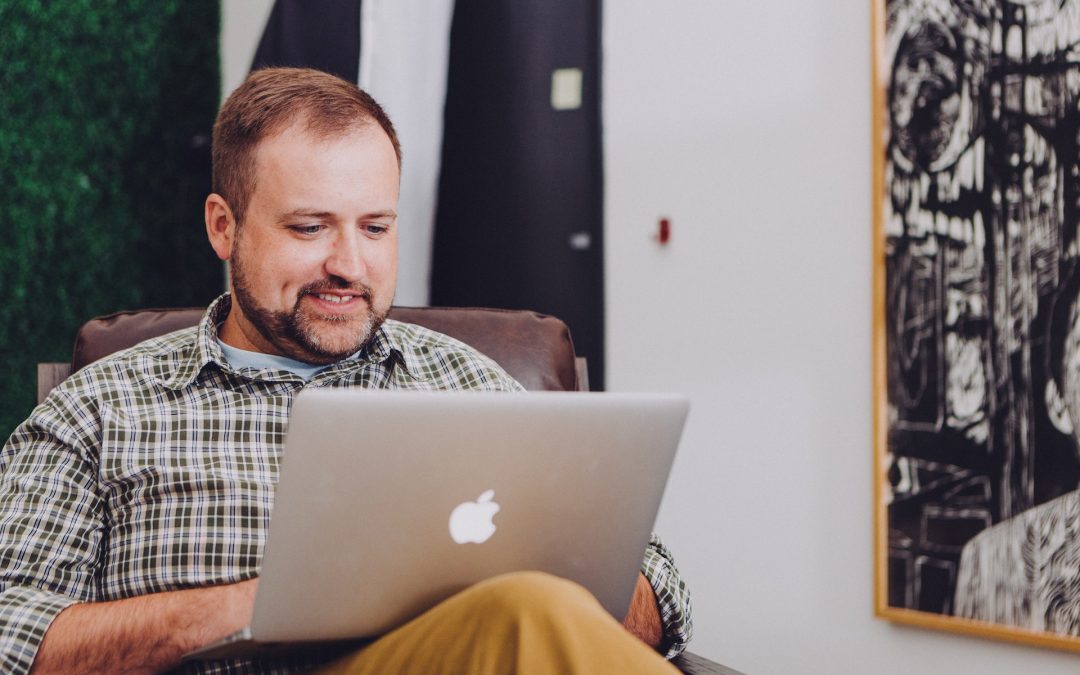man using laptop to look for real estate